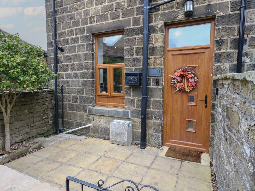 An entrance with a door and window at 11 Bronte Street in Haworth