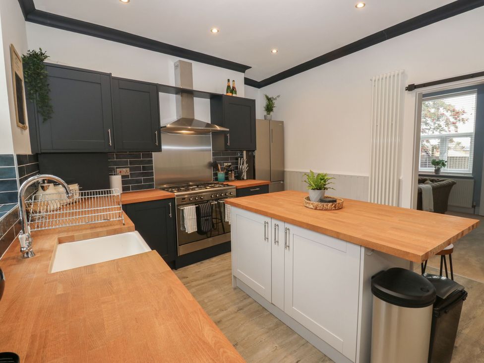 A kitchen with a sink and stove at 11 Bronte Street Haworth