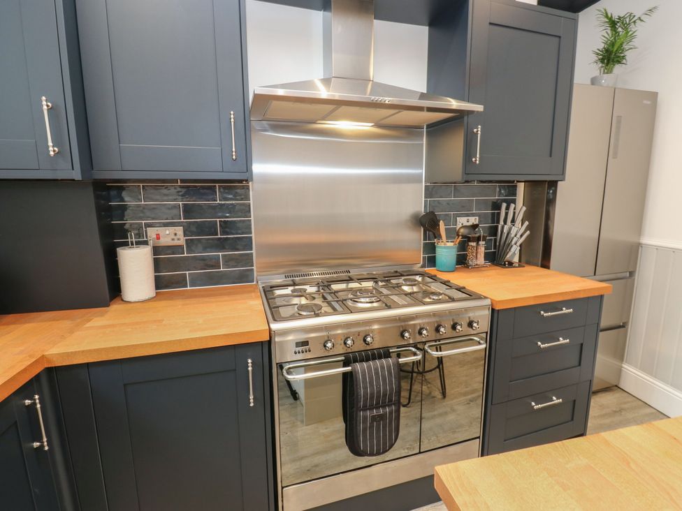 A kitchen with stove and cabinets at 11 Bronte Street Haworth