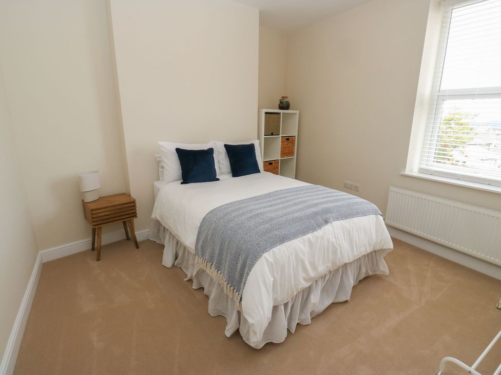 A bedroom with a bed and decorative pillows at 11 Bronte Street Haworth