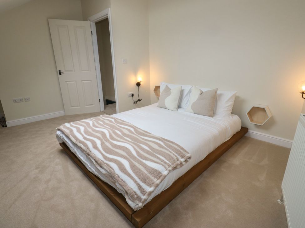 A bedroom with a bed and pillows at 11 Bronte Street in Haworth