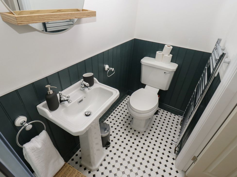 A bathroom with a sink and toilet at 11 Bronte Street in Haworth