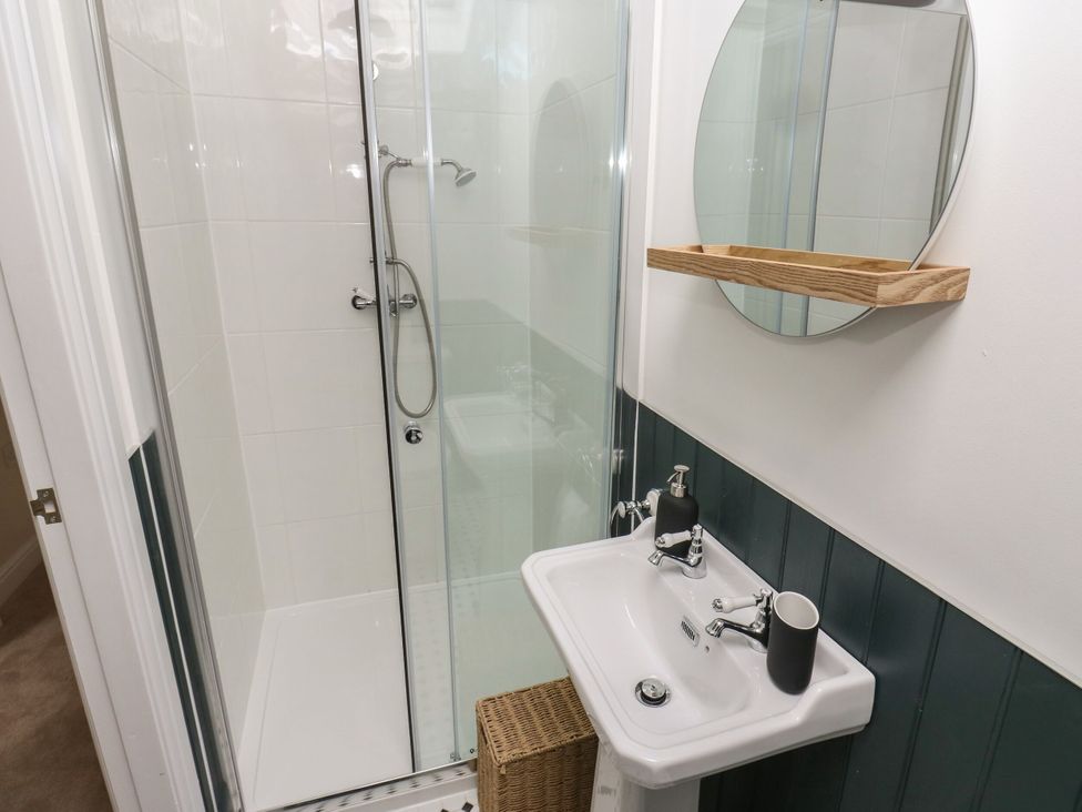 A bathroom with a shower and sink at 11 Bronte Street in Haworth