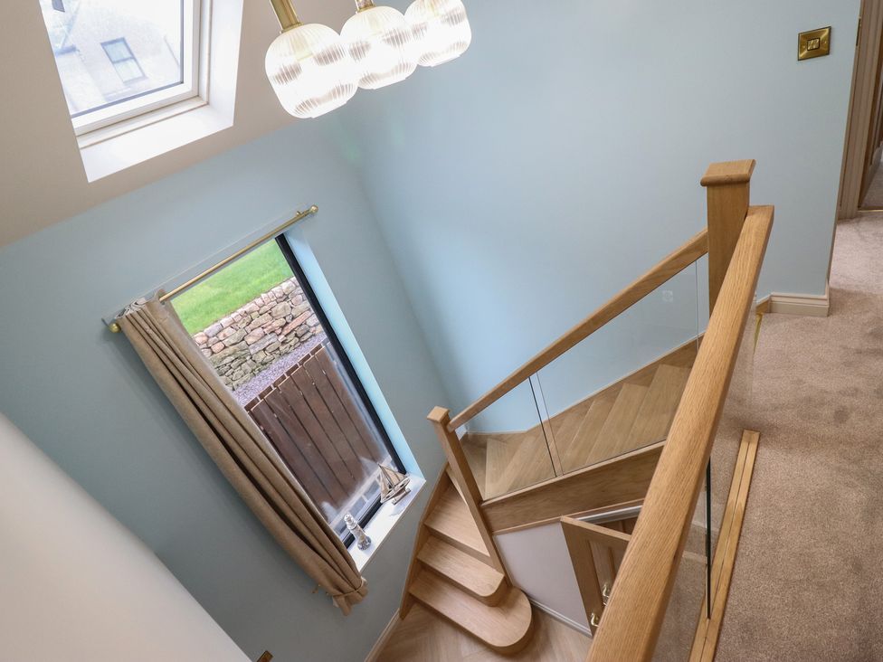 A stairwell with a staircase and window at Pistyll Ddu in Brynsiencyn near Llanfairpwllgwyngyll