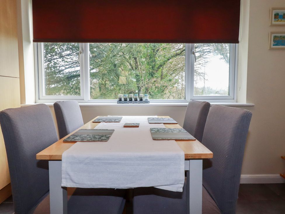 A dining room with a table and chairs at Poolside, Atlantic Reach resort, near St Columb Major