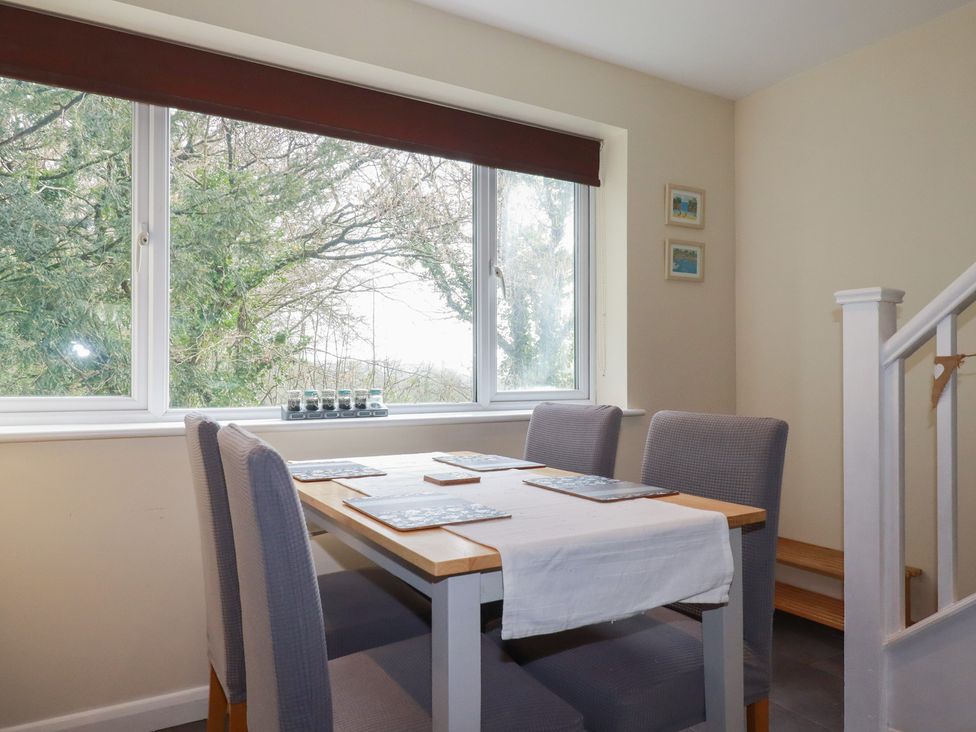 A dining room with a table and chairs at Poolside, Atlantic Reach resort, near St Columb Major