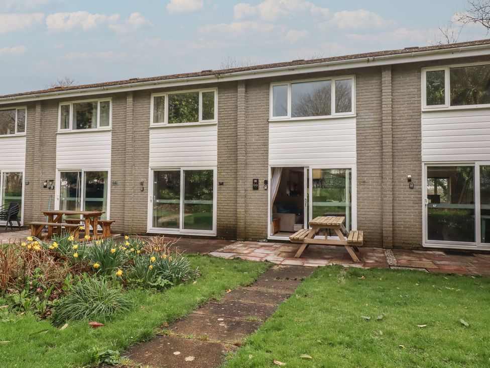 An exterior view of a building with a garden at Poolside, Atlantic Reach resort, near St Columb Major