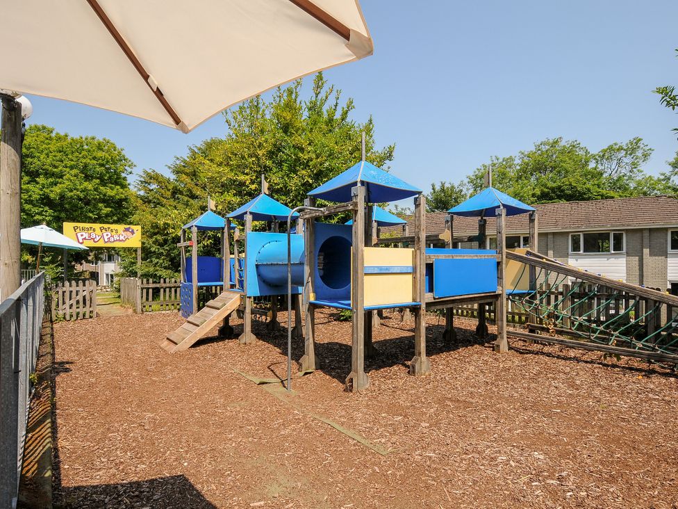 A playground with climbing equipment and a slide at Pirate Pete's Play Park in St Columb Major