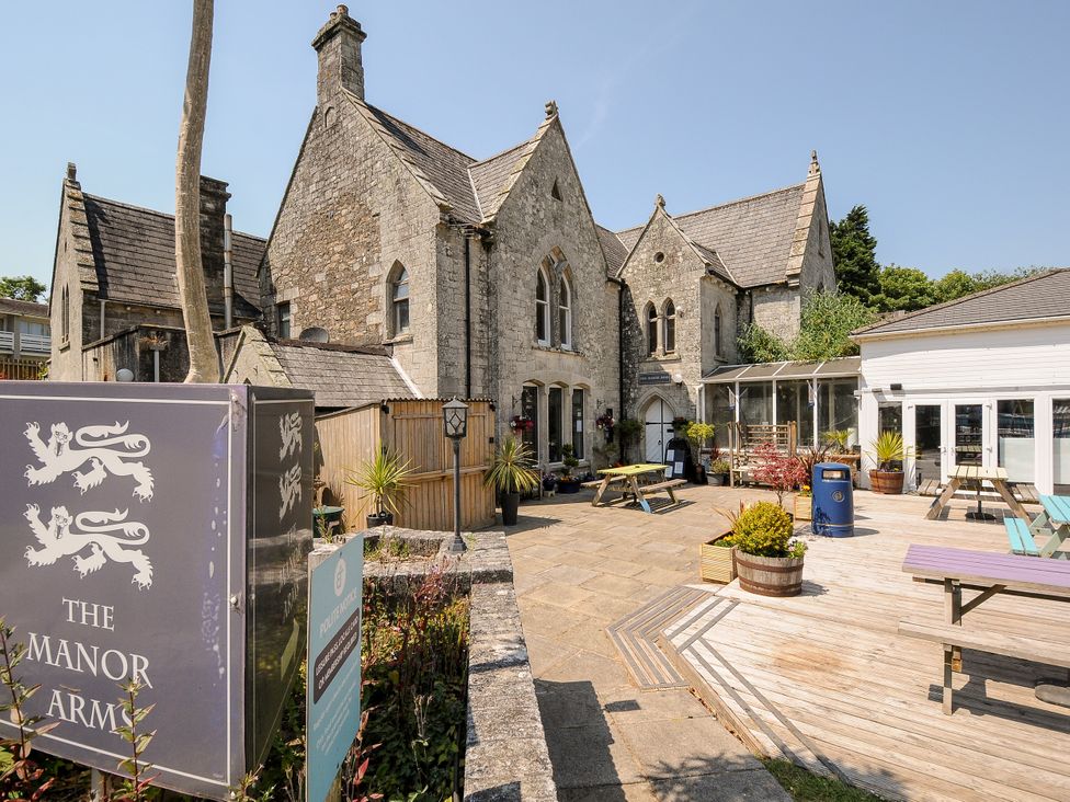 An outdoor area with tables and plants at The Manor Arms in St Columb Major