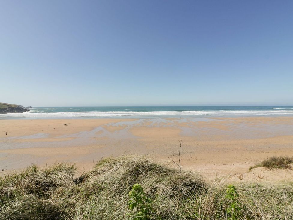 A beach with sand and ocean view at Poolside in St Columb Major