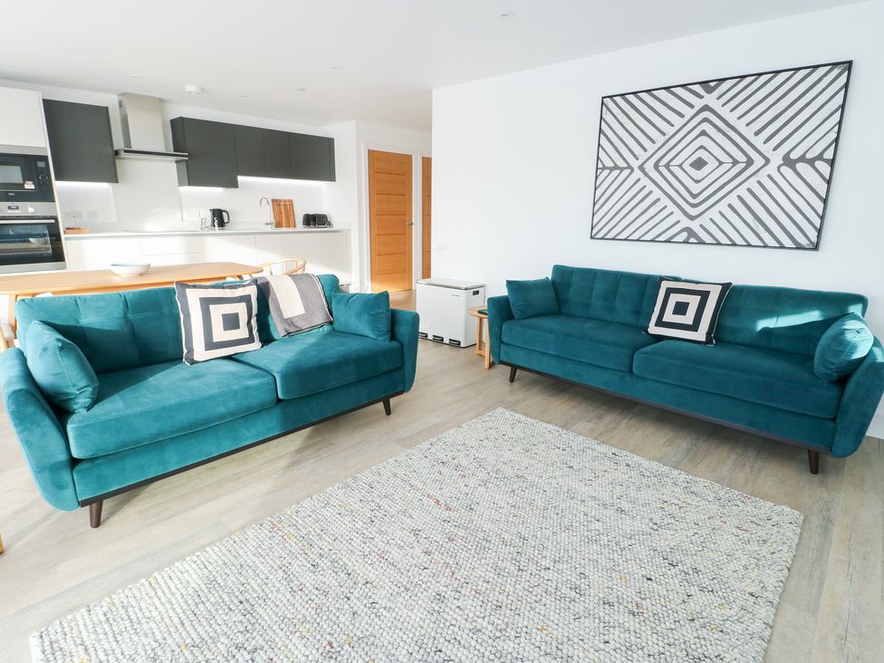 A living room with two sofas and a coffee table at Glynllifon 4 in Marianglas