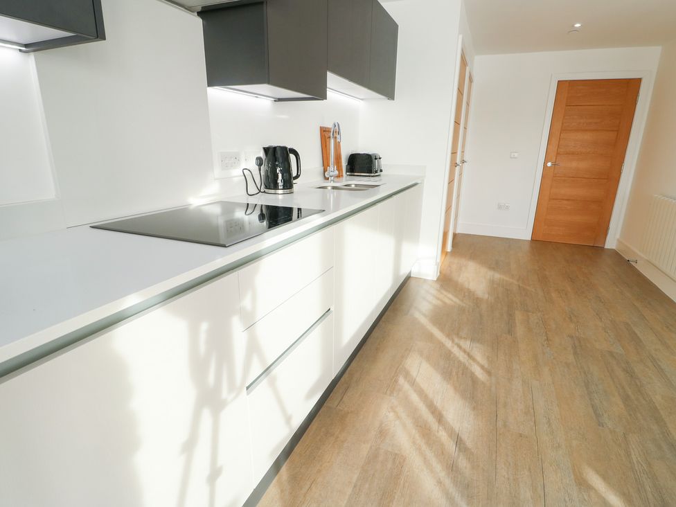 A kitchen with a cooker and kettle at Glynllifon 4 in Marianglas