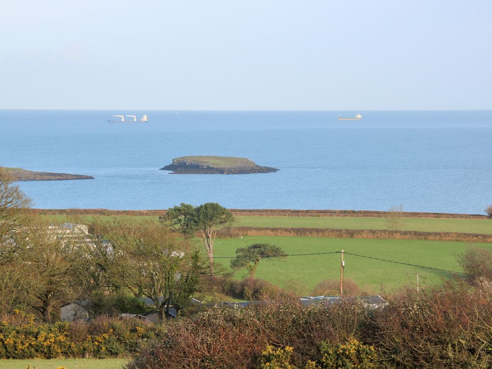 A view of water with an island and ships at Glynllifon 6, Marianglas
