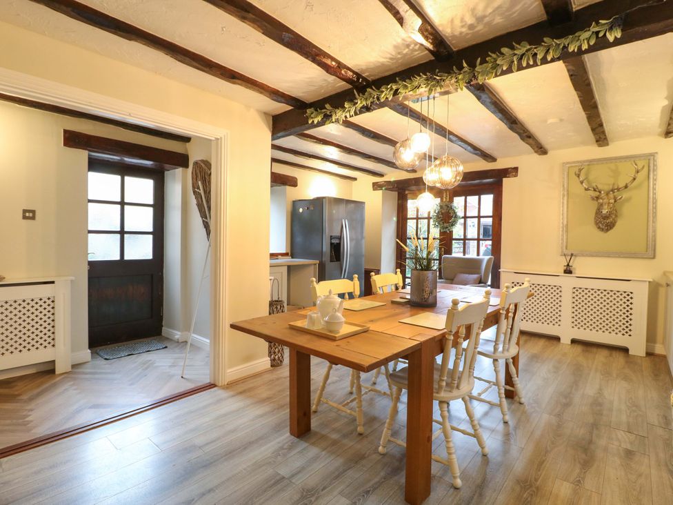 A dining room with a table and chairs at Magnolia Cottage Nottingham