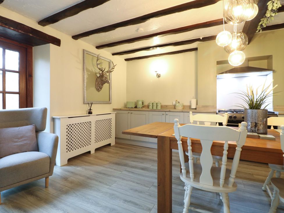 A kitchen with a dining table and chairs at Magnolia Cottage in Nottingham