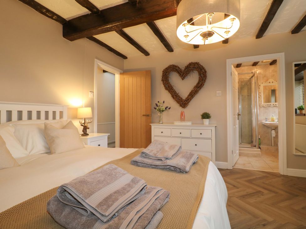 A bedroom with a bed and chest of drawers at Magnolia Cottage in Nottingham