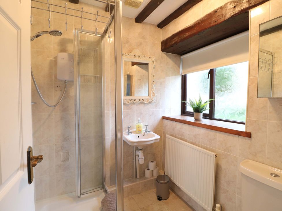 A bathroom with a shower and sink at Magnolia Cottage Nottingham