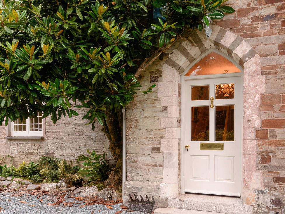 An entrance door with a tree beside it at Ladye Park in Liskeard