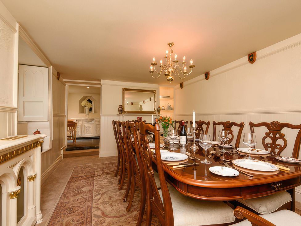 A dining room with a table set for a meal at Ladye Park in Liskeard