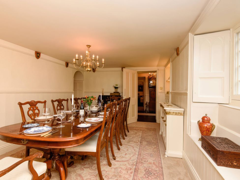 A dining room with a large table set for a meal at Ladye Park in Liskeard