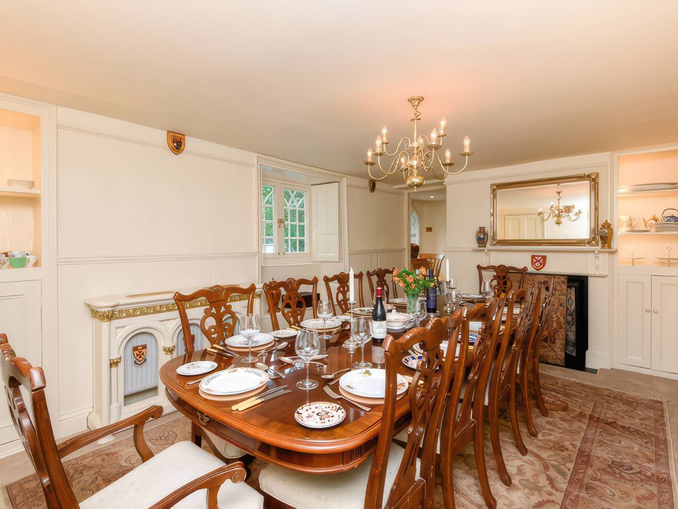 A dining room with a table set for dinner at Ladye Park in Liskeard