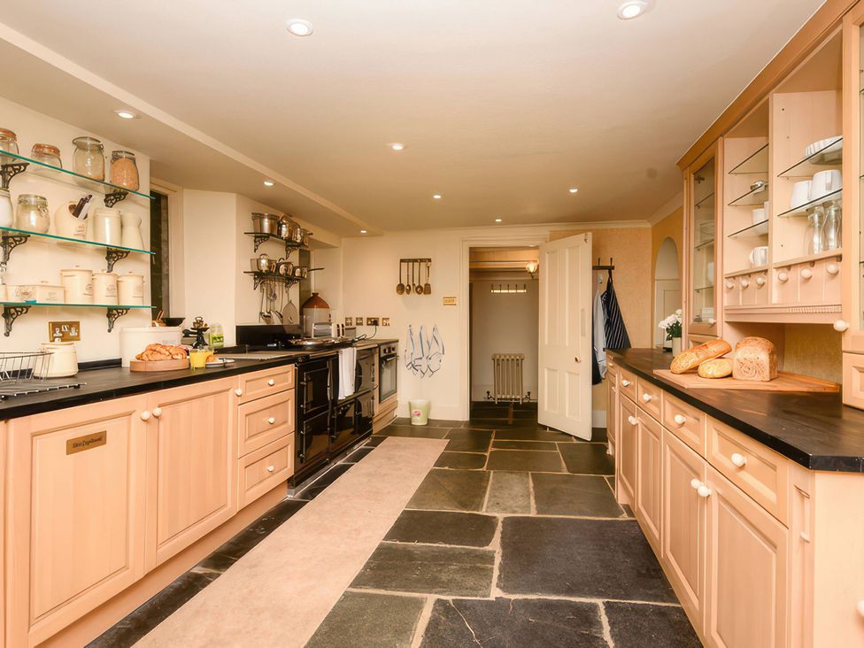 A kitchen with cabinets and a stove at Ladye Park in Liskeard