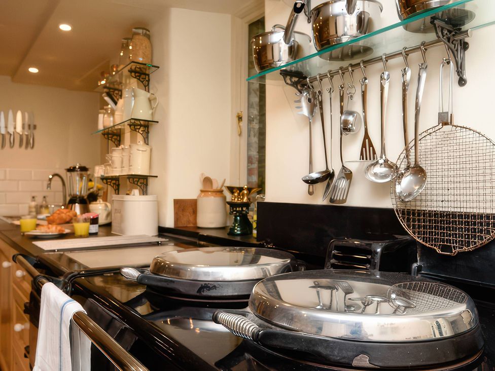 A kitchen with cooking utensils and cookware on display at Ladye Park in Liskeard