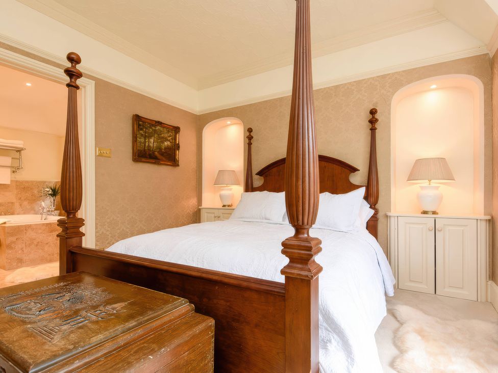 A bedroom featuring a four-poster bed and nightstands at Ladye Park in Liskeard