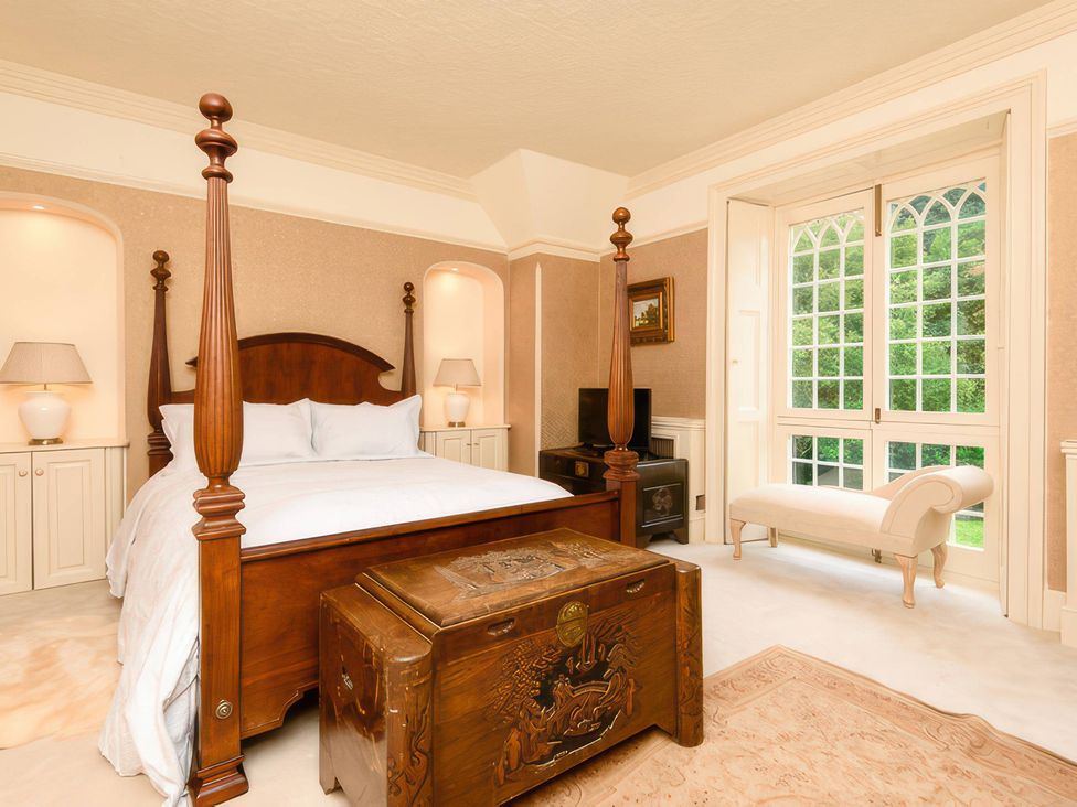 A bedroom with a bed and a chest at Ladye Park in Liskeard