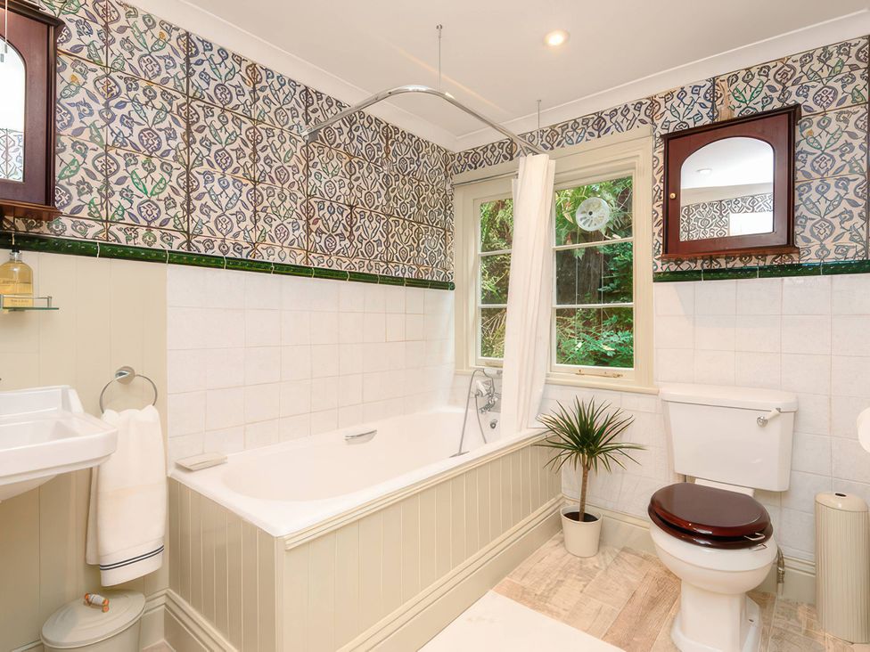 A bathroom with a bathtub and sink at Ladye Park in Liskeard