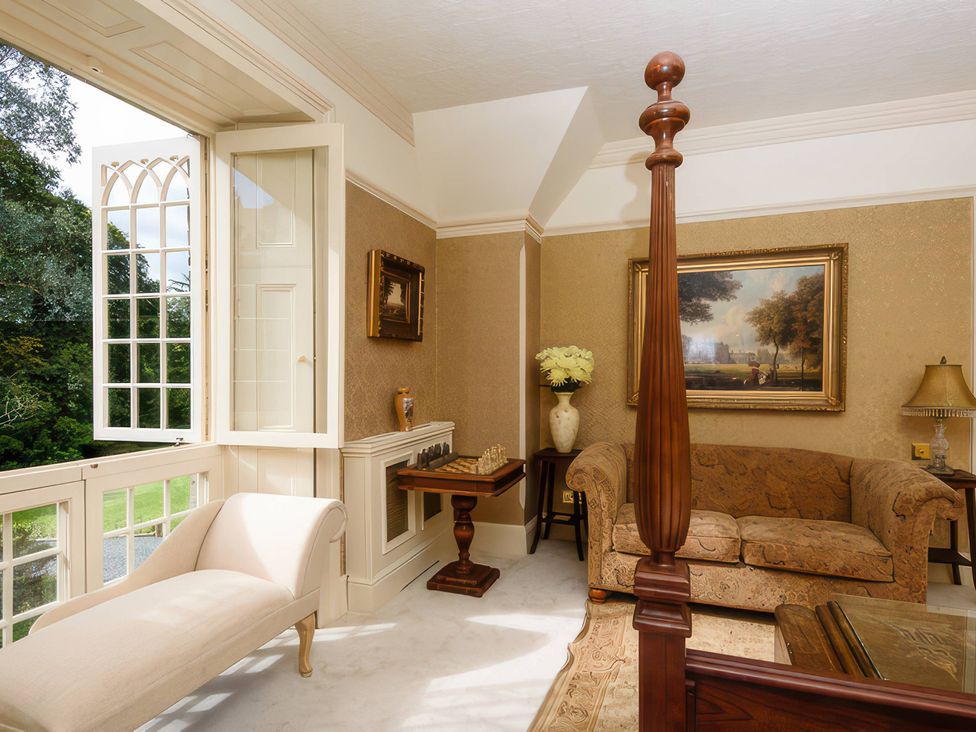 A living room with a sofa and window at Ladye Park in Liskeard