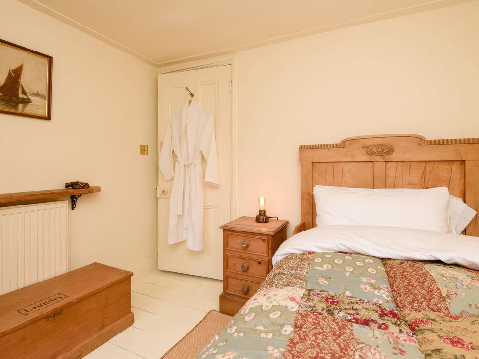A bedroom with a bed and bedside table at Ladye Park in Liskeard