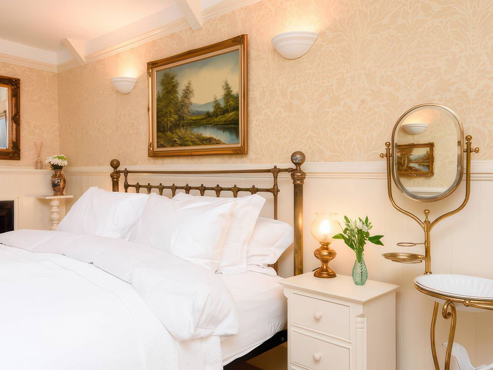 A bedroom with a bed and nightstand at Ladye Park in Liskeard