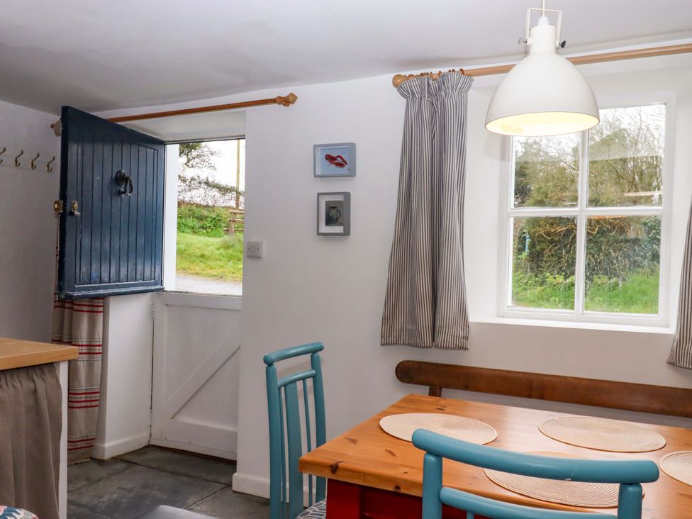 A dining room with a table and chairs at Old Sunday School Welcombe near Kilkhampton