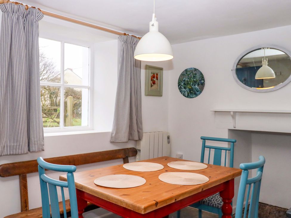 A dining room with a table and chairs at Old Sunday School in Welcombe near Kilkhampton