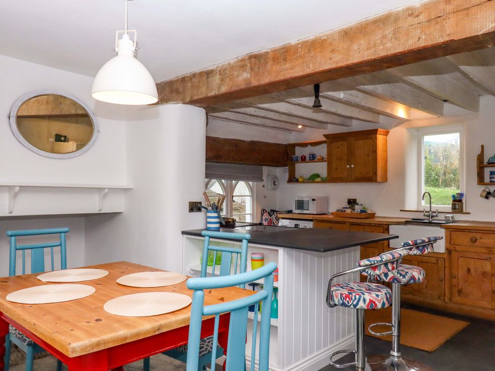 A kitchen with a table and chairs at Old Sunday School in Welcombe near Kilkhampton