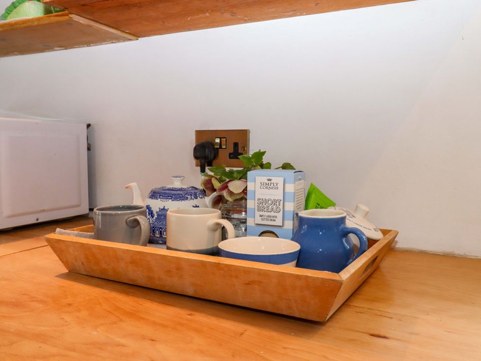 A kitchen counter with cups and a teapot on a tray at Old Sunday School in Welcombe near Kilkhampton