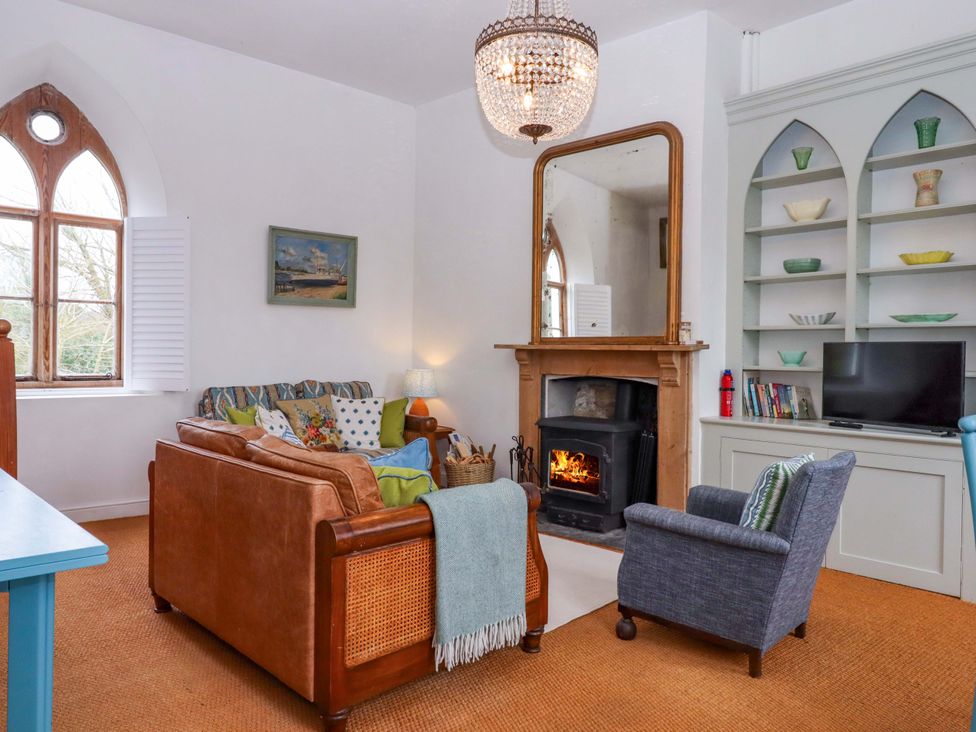 A living room with a sofa and armchair at the Old Sunday School Welcombe near Kilkhampton