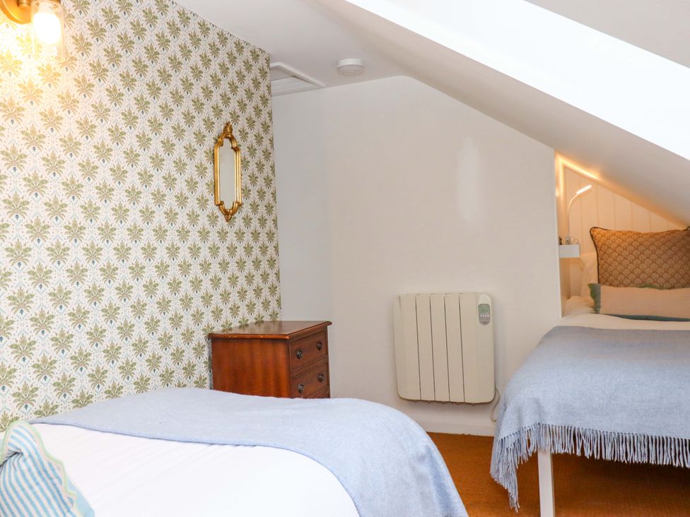 A bedroom with a bed and nightstand at The Old Sunday School in Welcombe near Kilkhampton