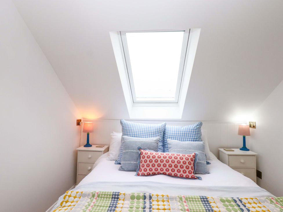 A bedroom with a bed and pillows at Old Sunday School in Welcombe near Kilkhampton