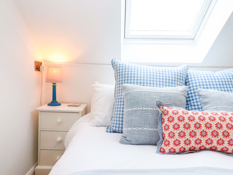 A bedroom with a bed and pillows at Old Sunday School in Welcombe near Kilkhampton
