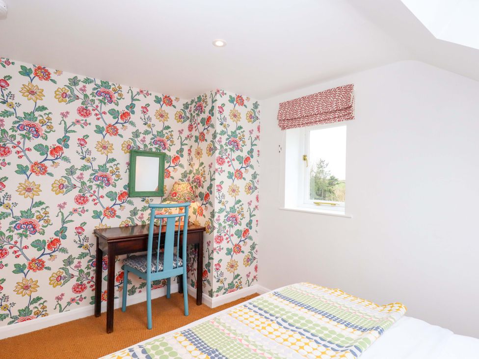 A bedroom with a desk and chair at Old Sunday School, Welcombe near Kilkhampton