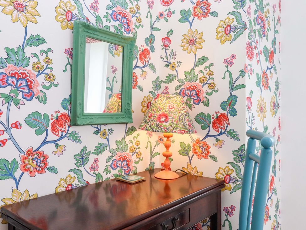 A table with a lamp and mirror at Old Sunday School, Welcombe near Kilkhampton