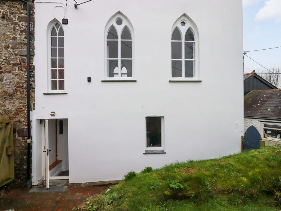 An outdoor view of a building with windows and a door at Old Sunday School Welcombe near Kilkhampton