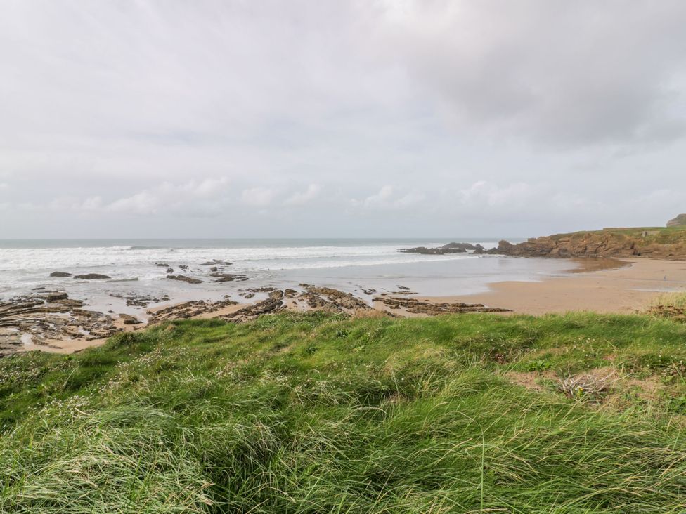 A beach scene with rocks and grass at Old Sunday School, Welcombe near Kilkhampton