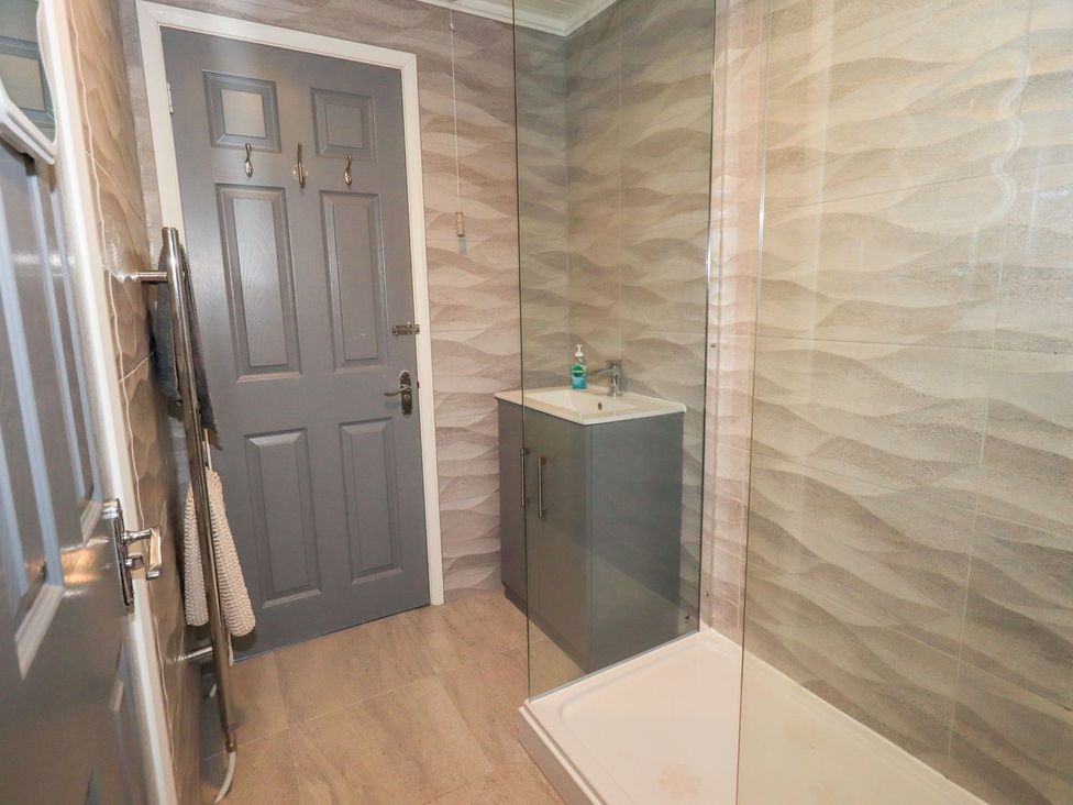 A bathroom with a shower and sink at Evermore Lodge, 48 Calgarth Park, White Cross Bay, Windermere