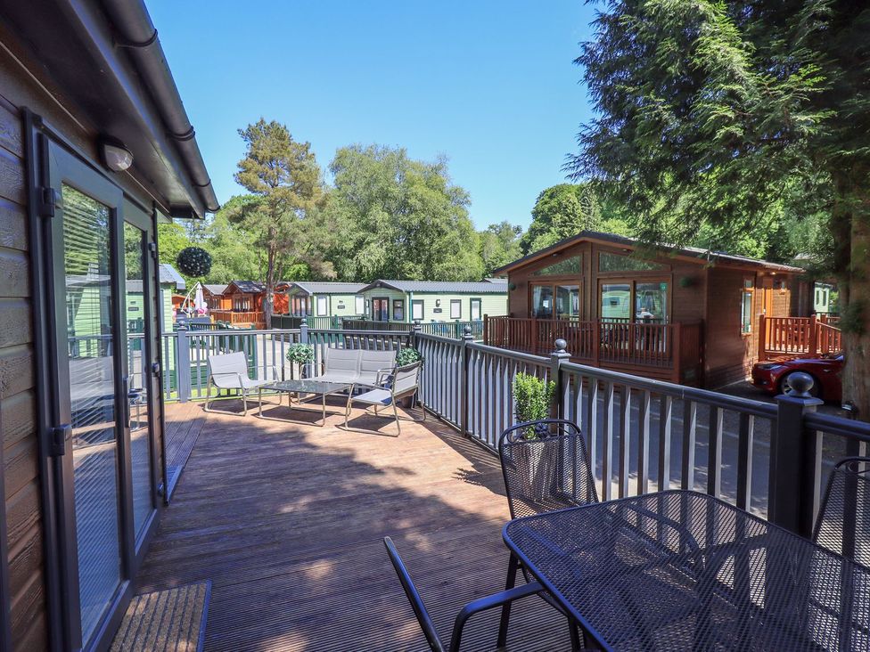 An outdoor area with a deck and seating at Evermore Lodge, 48 Calgarth Park, White Cross Bay, Windermere