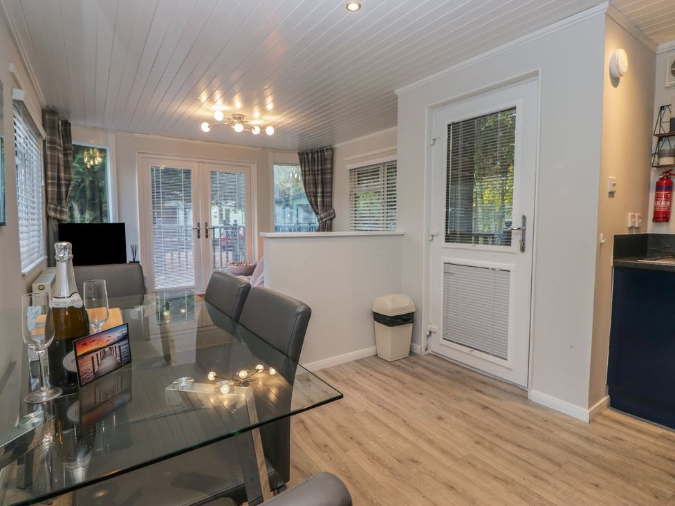 A dining room with a table and chairs at Evermore Lodge, 48 Calgarth Park, White Cross Bay, Windermere