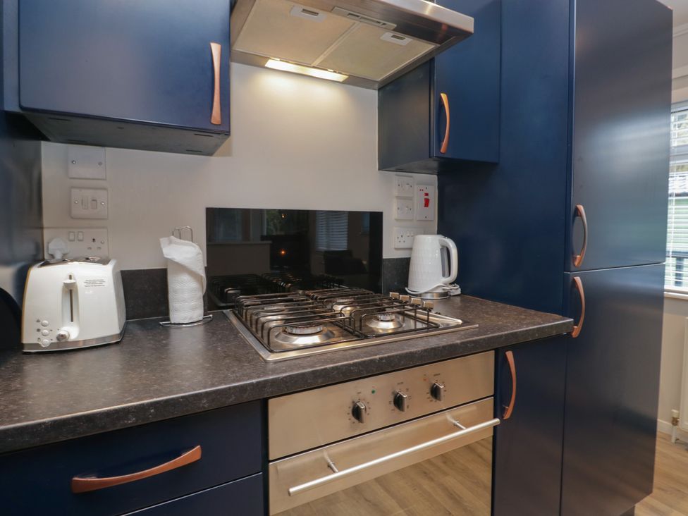 A kitchen with a hob, toaster, and kettle at Evermore Lodge 48 Calgarth Park, White Cross Bay, Windermere