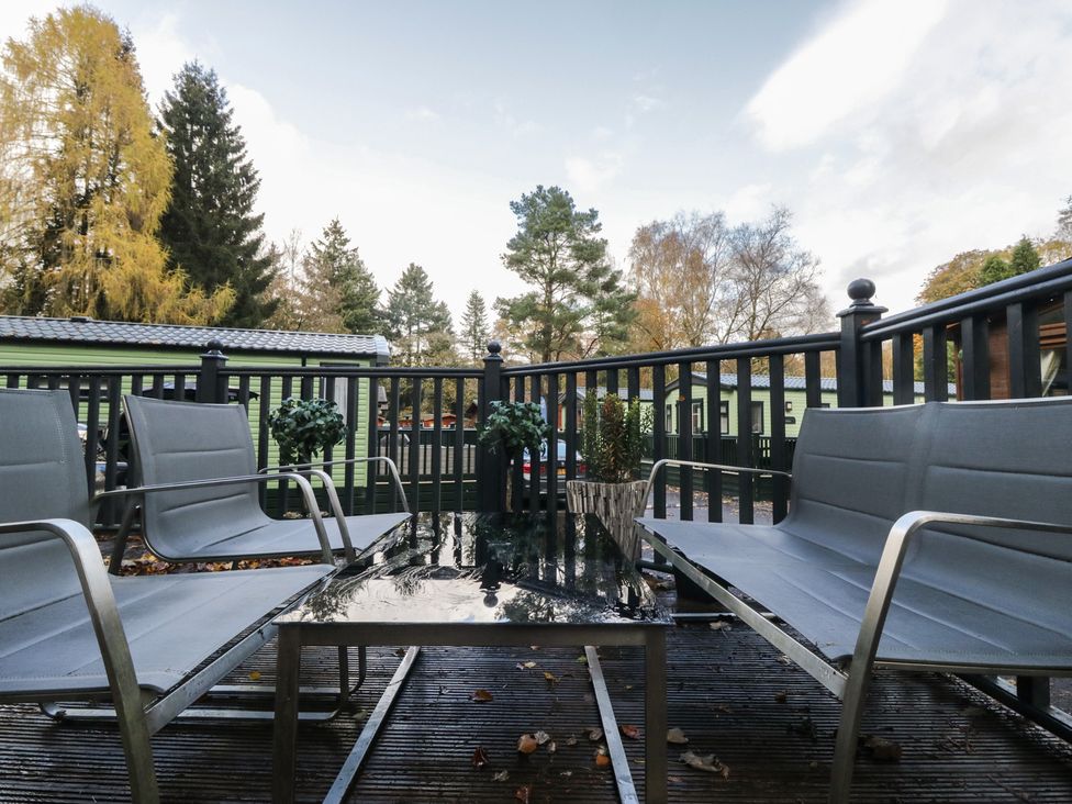 A seating area with chairs and a table at Evermore Lodge, 48 Calgarth Park, White Cross Bay, Windermere